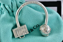 Load image into Gallery viewer, Tiffany &amp; Co. Silver World Globe &amp; Travel NYC USA Suitcase Horseshoe Keychain
