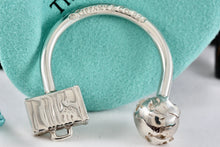 Load image into Gallery viewer, Tiffany &amp; Co. Silver World Globe &amp; Travel NYC USA Suitcase Horseshoe Keychain
