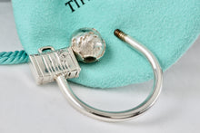 Load image into Gallery viewer, Tiffany &amp; Co. Silver World Globe &amp; Travel NYC USA Suitcase Horseshoe Keychain
