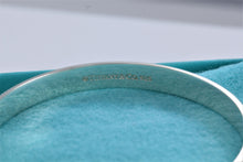 Load image into Gallery viewer, Tiffany &amp; Co. Silver Yours &#39;&#39;Love Makes The World Go Round&#39;&#39; Beaded Edge Bangle Bracelet

