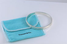 Load image into Gallery viewer, Tiffany &amp; Co. Silver Yours &#39;&#39;Love Makes The World Go Round&#39;&#39; Beaded Edge Bangle Bracelet
