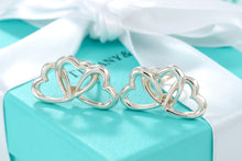 Load image into Gallery viewer, Tiffany &amp; Co. Silver Triple interlocking Heart Clip-On Earrings
